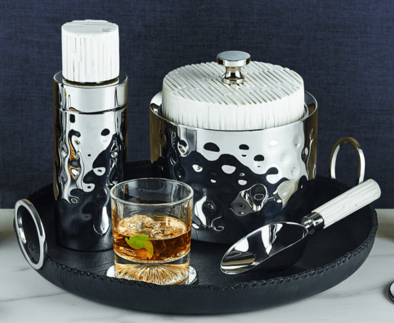 A black leather tray with bar accessories