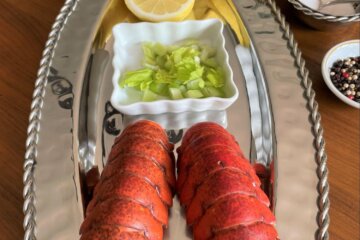 Classic Maine lobster tails on a stainless steel platter