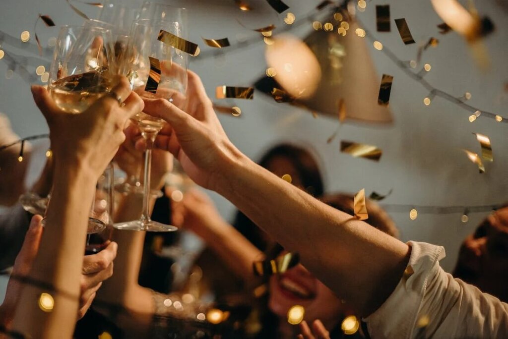A group of people toasting glasses on New Year’s Eve