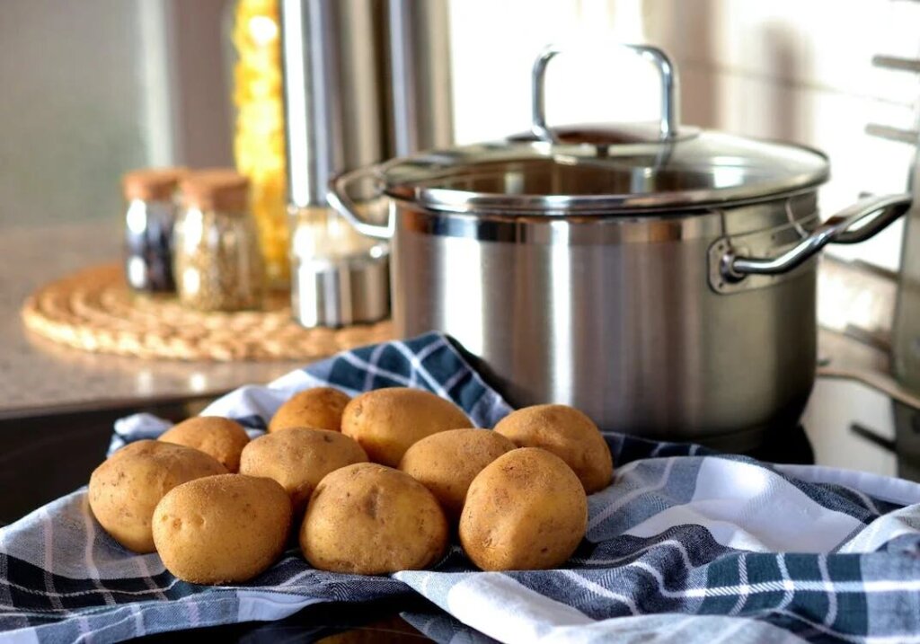 Potatoes beside a cooking pot