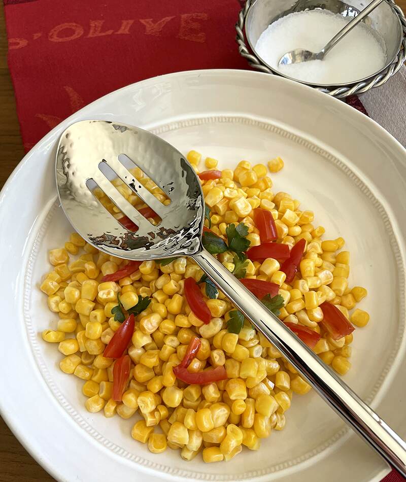 A corn salad with the Versa Slotted Serving Spoon