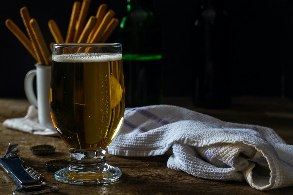 A beer glass beside a white towel