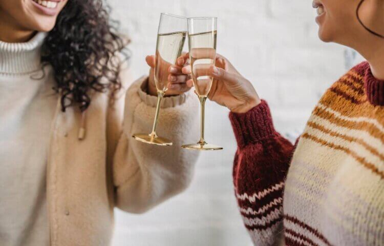 Two women toasting Champagne glasses